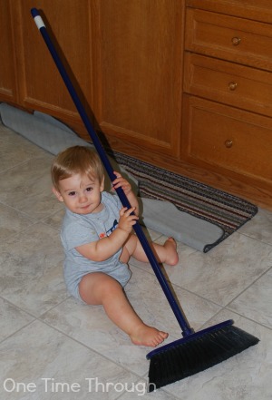 Toddler sweeping floor